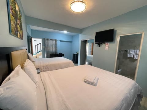 Family Room, 2 Queen Beds | Iron/ironing board, WiFi (free), bed sheets