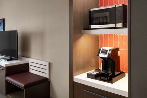 Desk, laptop workspace, iron/ironing board, bed sheets