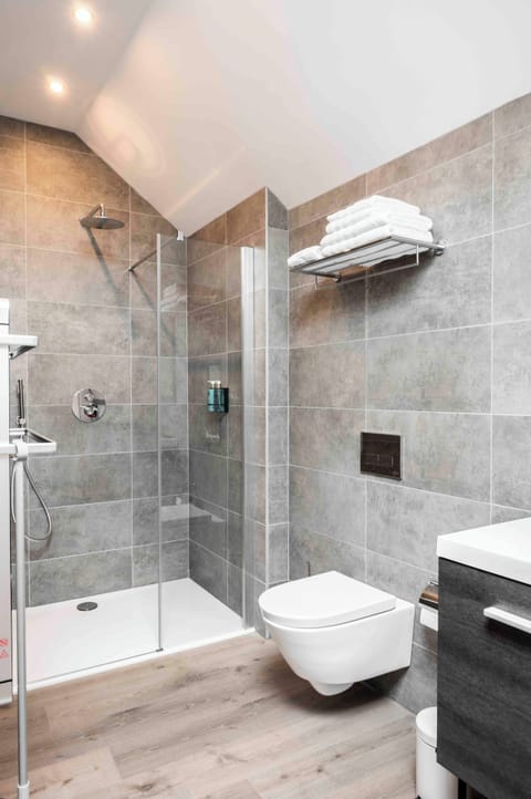 Shower, rainfall showerhead, hair dryer, towels