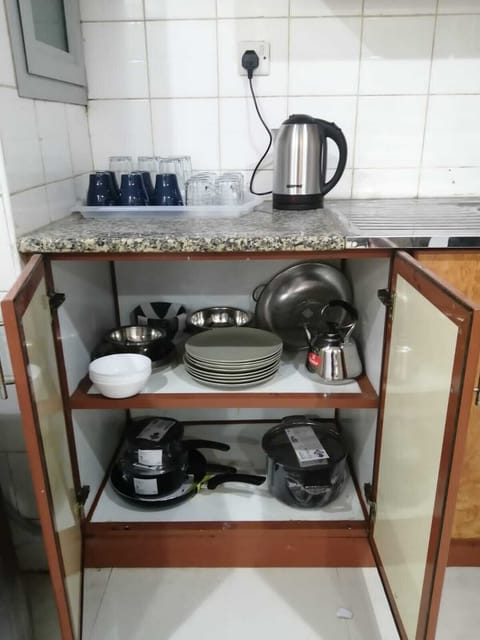 Full-size fridge, microwave, cookware/dishes/utensils, cleaning supplies