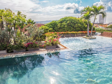 Outdoor pool, open 10:00 AM to 8:00 PM, pool umbrellas