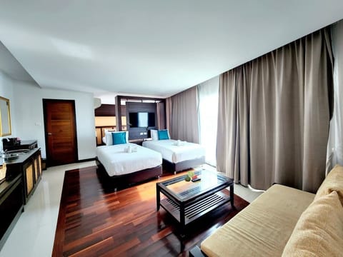Family Quadruple Room | Living area | 32-inch flat-screen TV with cable channels, TV