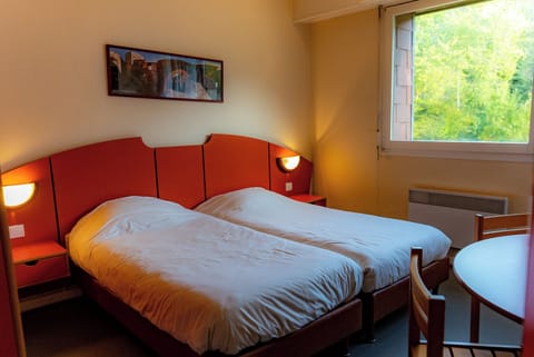 Desk, laptop workspace, bed sheets