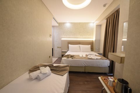 Family Triple Room | Hypo-allergenic bedding, minibar, in-room safe, soundproofing