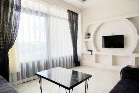 Luxury Apartment, Multiple Beds, Hot Tub | Living area | 40-inch LED TV with satellite channels, TV