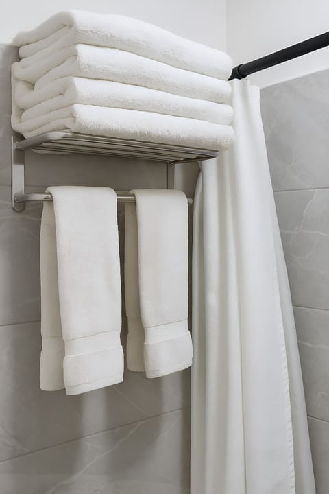 Luxury Quadruple Room, Multiple Beds, Air conditioning, City View | Bathroom | Shower, rainfall showerhead, hair dryer, towels