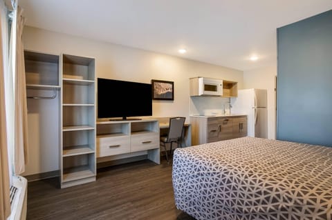 Desk, laptop workspace, blackout drapes, iron/ironing board