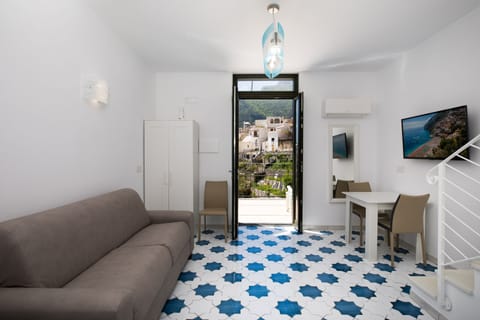 Family Studio, Sea View | Living area | 40-inch flat-screen TV with digital channels, TV