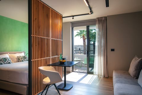 Exclusive Triple Room | Living area | Flat-screen TV