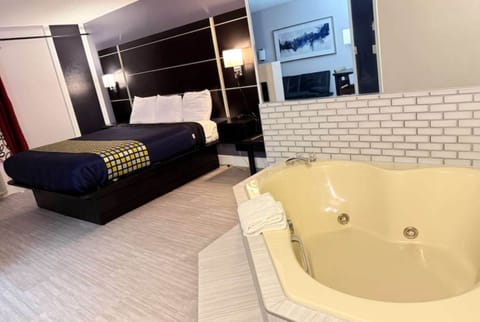 1 King Suite Jacuzzi, Non Smoking | Hypo-allergenic bedding, in-room safe, laptop workspace, blackout drapes