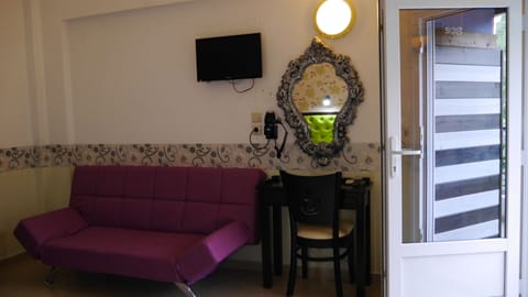 Family Studio, Garden View | Living area | 32-inch flat-screen TV with satellite channels, TV