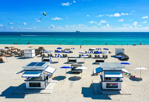 On the beach, white sand, beach umbrellas, beach towels