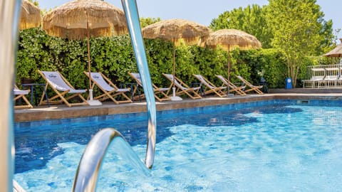 Seasonal outdoor pool, open 9:00 AM to 9:00 PM, pool umbrellas