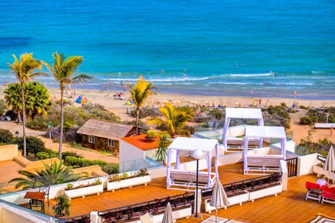 On the beach, white sand, sun loungers, beach umbrellas