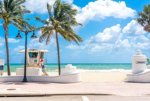 Beach nearby, white sand, beach umbrellas, beach towels