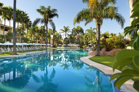 Seasonal outdoor pool, open 11:00 AM to 7:00 PM, pool umbrellas