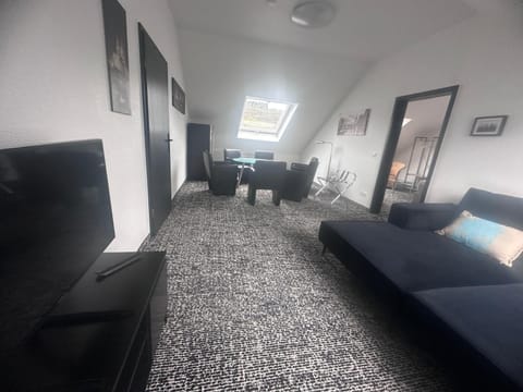 Family Apartment, 3 Bedrooms, River View | Living area | 32-inch LED TV with cable channels, TV, offices