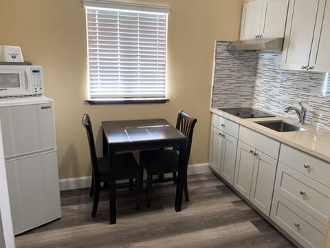 Desk, laptop workspace, blackout drapes, iron/ironing board