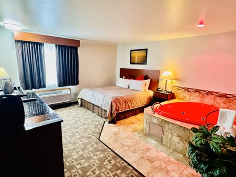 Standard Room, 1 King Bed, Non Smoking, Jetted Tub | Desk, blackout drapes, iron/ironing board, free cribs/infant beds