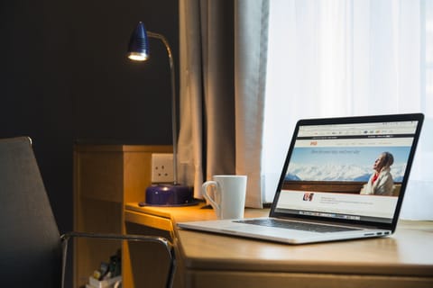 Desk, laptop workspace, blackout drapes, iron/ironing board