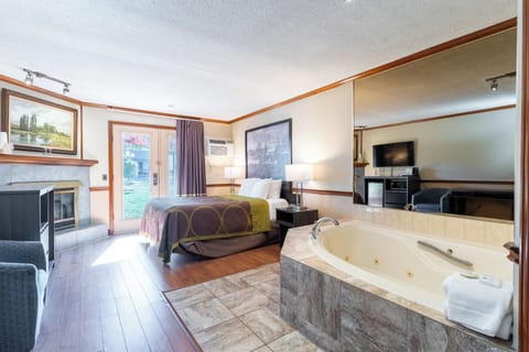 Suite, 1 King Bed, Non Smoking | Desk, laptop workspace, blackout drapes, iron/ironing board