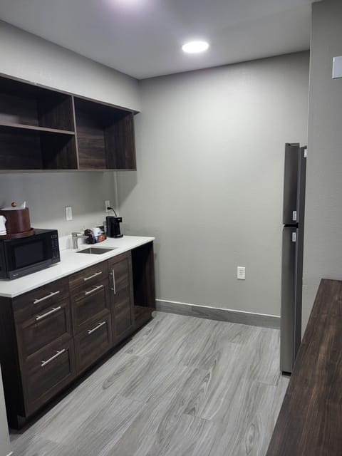 Suite, 1 King Bed, Non Smoking | Desk, laptop workspace, blackout drapes, iron/ironing board