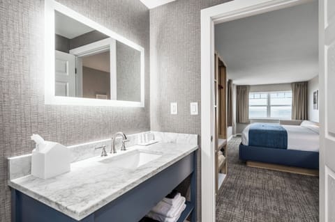 Lakeview Corner King Room | Bathroom | Designer toiletries, hair dryer, towels, soap
