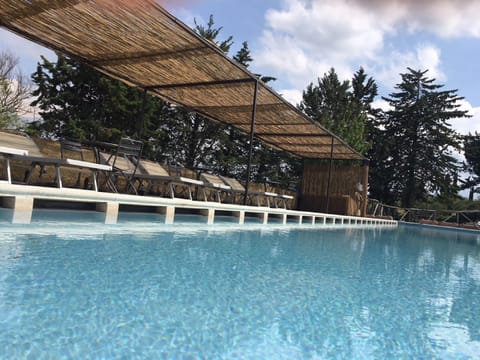 Seasonal outdoor pool, open 9:00 AM to 8 PM, pool umbrellas