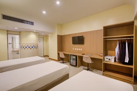 Deluxe Triple Room | Minibar, in-room safe, desk, soundproofing