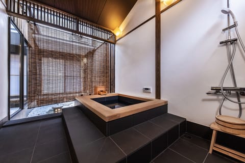 Traditional Townhome | Bathroom | Separate tub and shower, deep soaking tub, hair dryer, slippers
