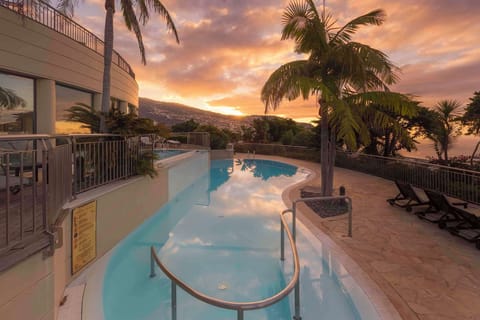Indoor pool, outdoor pool, open 10:00 AM to 6:00 PM, pool umbrellas