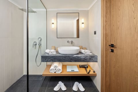 Designer toiletries, hair dryer, slippers, towels