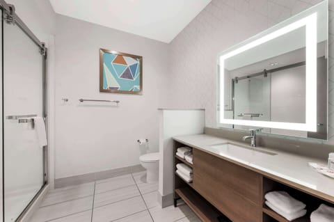 Premium bedding, desk, laptop workspace, blackout drapes