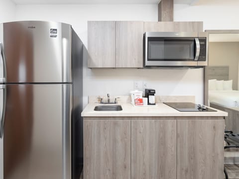 Full-size fridge, microwave, stovetop, cookware/dishes/utensils