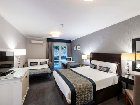 Desk, laptop workspace, blackout drapes, iron/ironing board