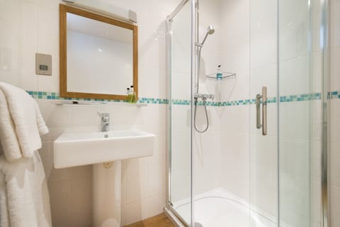 Shower, designer toiletries, hair dryer, towels