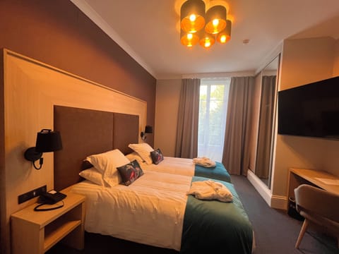 Premium bedding, desk, laptop workspace, blackout drapes