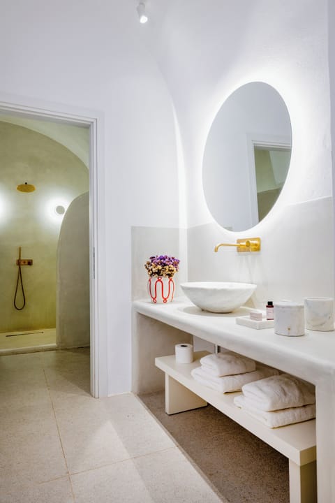 Designer toiletries, hair dryer, slippers, towels