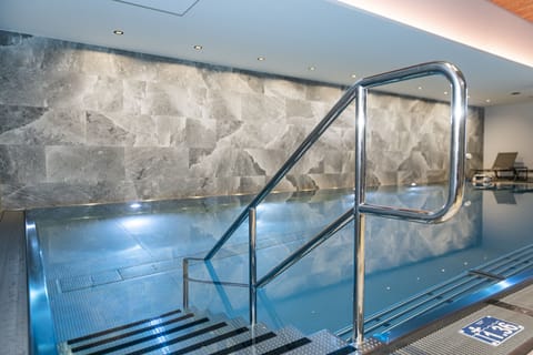 Indoor pool, open 7:00 AM to 10:00 PM, sun loungers