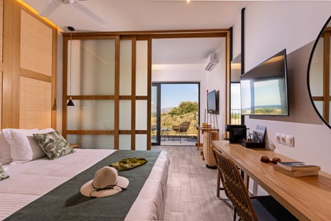 Junior Suite, Partial Sea View | 1 bedroom, free minibar items, in-room safe, desk