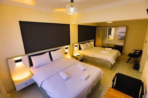 Standard Quadruple Room | In-room safe, individually decorated, individually furnished, desk