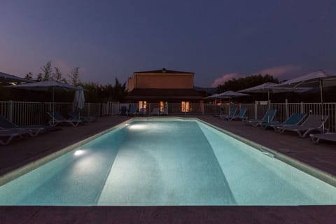 Seasonal outdoor pool, open 7:00 AM to 10:00 PM, pool umbrellas