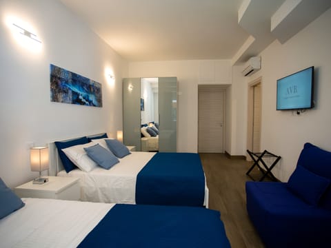 Family Quadruple Room | In-room safe, desk, laptop workspace, blackout drapes