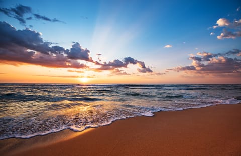 On the beach, white sand, beach cabanas, sun loungers