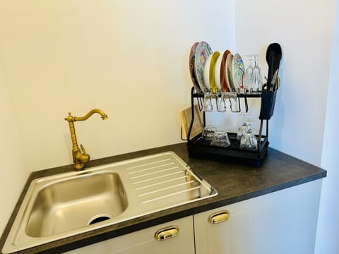 Full-size fridge, stovetop, electric kettle, cookware/dishes/utensils