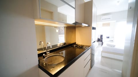 Full-size fridge, stovetop, rice cooker, cookware/dishes/utensils