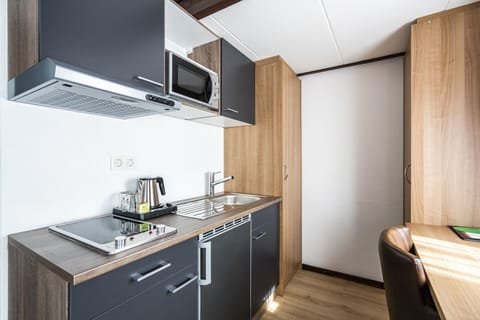 Studio | Desk, laptop workspace, blackout drapes, iron/ironing board