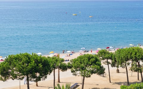 Beach nearby, white sand, beach umbrellas, beach towels