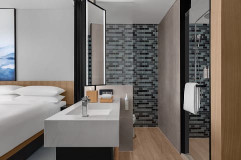 Room, 1 King Bed | Bathroom | Shower, rainfall showerhead, slippers, towels