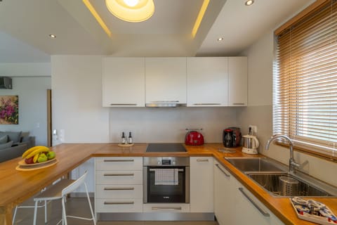 Junior Suite, Pool View | Private kitchen | Full-size fridge, oven, stovetop, espresso maker